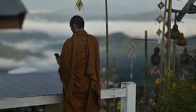Buddhist Monk checking his Smartphone, Thailand